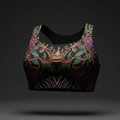 Black sports bra with golden crown, purple floral, and vine tattoo-style print on a longline racerback silhouette.